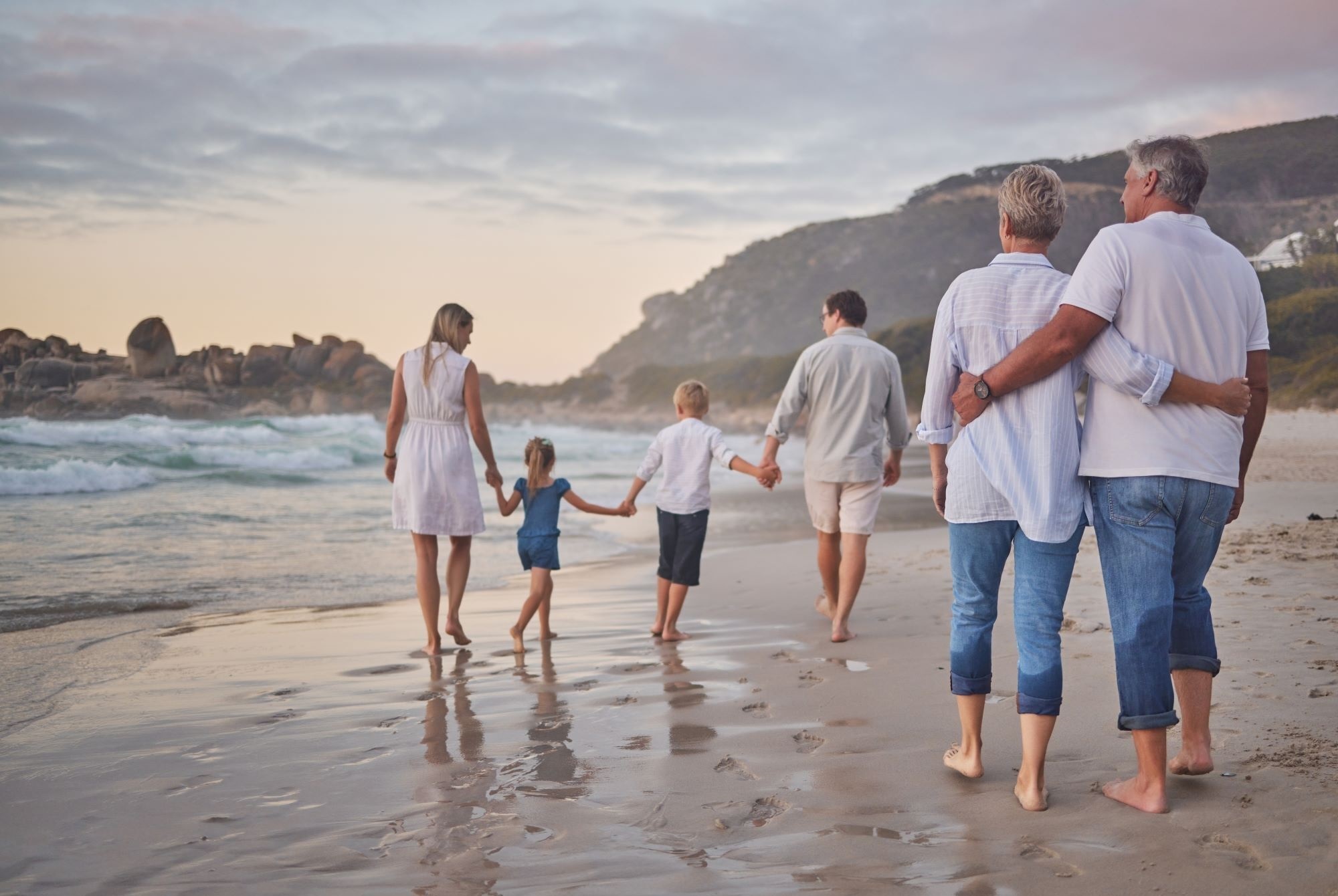 Family walking on the side of the beach