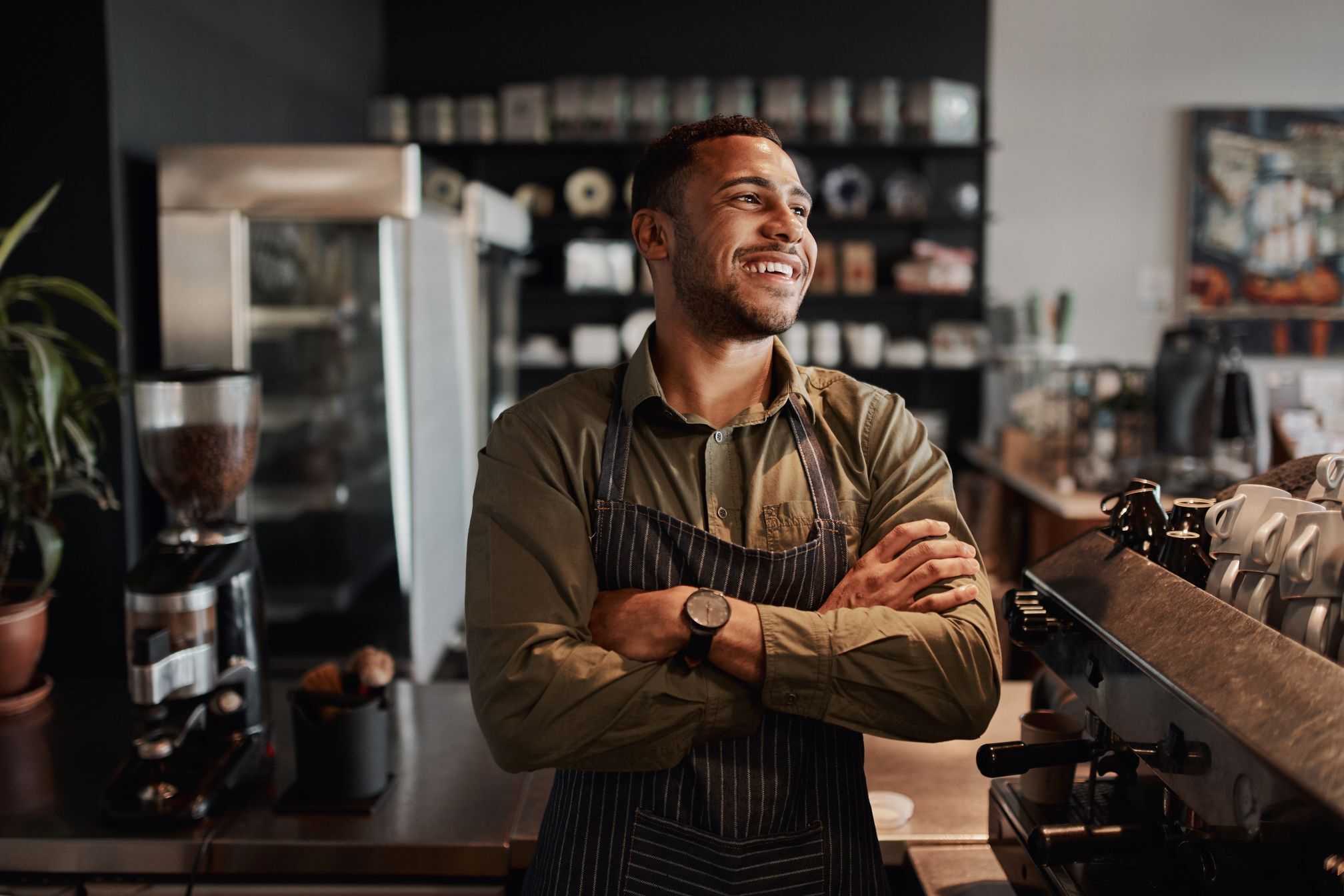 Young afro-american small coffee shop owner